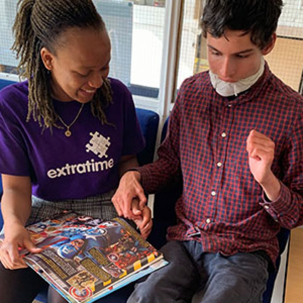 Play Worker showing picture book to a young person