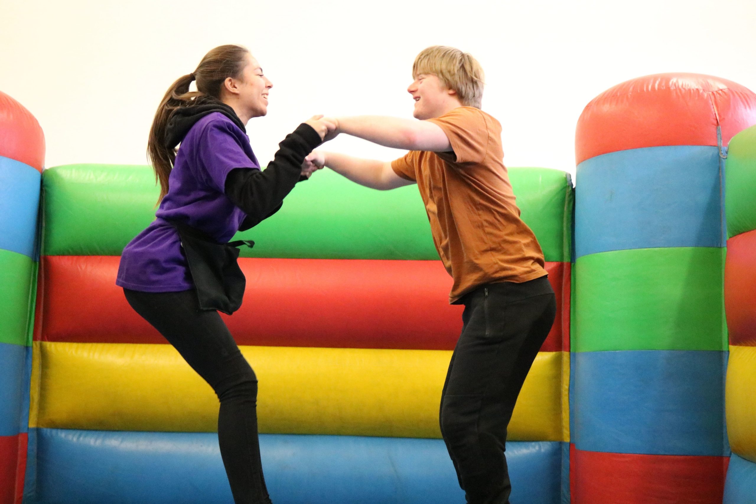 Play Worker and young person on a bouncy castle